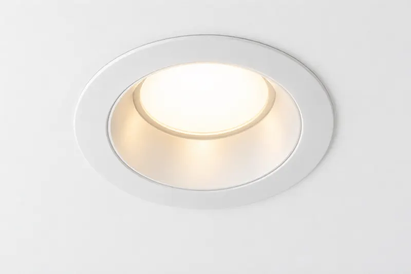 A glowing recessed ceiling light